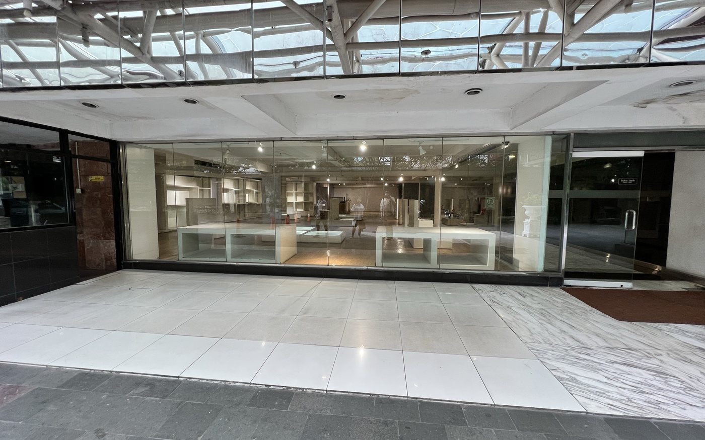 An empty, glass-fronted retail unit after a store closed
